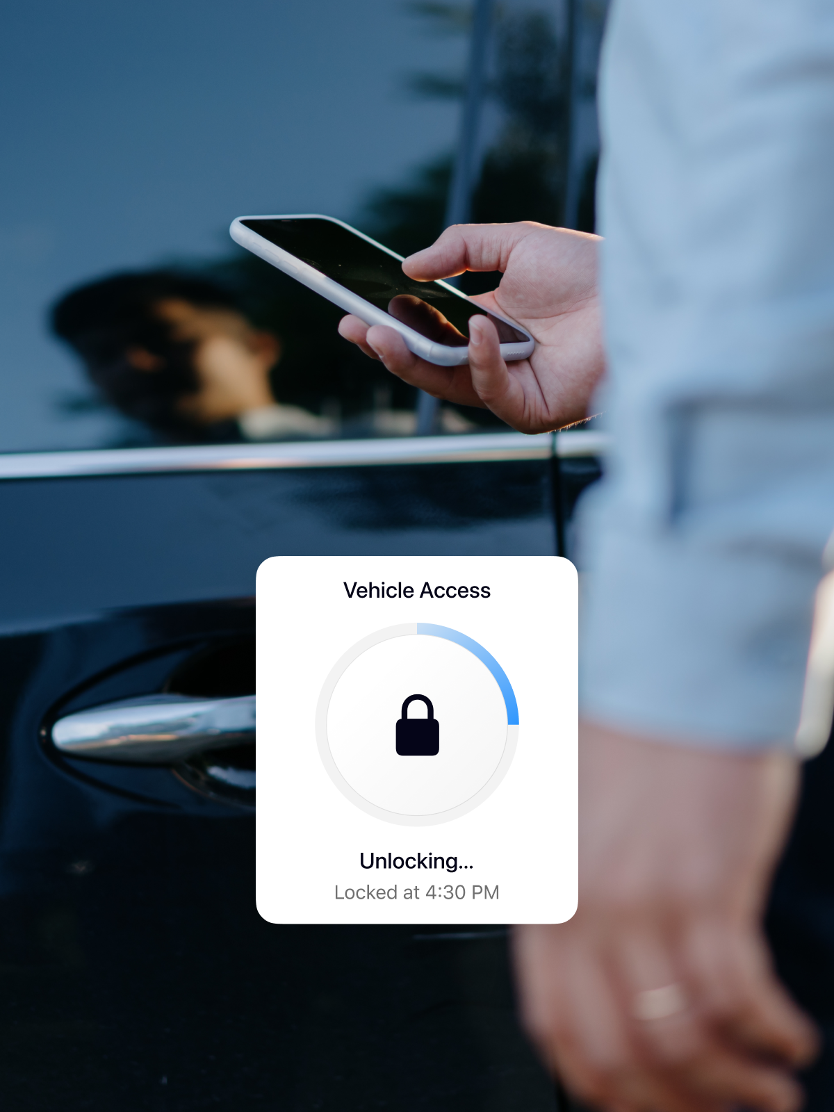 A person holding a smartphone in front of a black car door, with a vehicle access screen displaying 'Unlocking...' and a status indicator. The car handle is visible, reflecting sunlight.